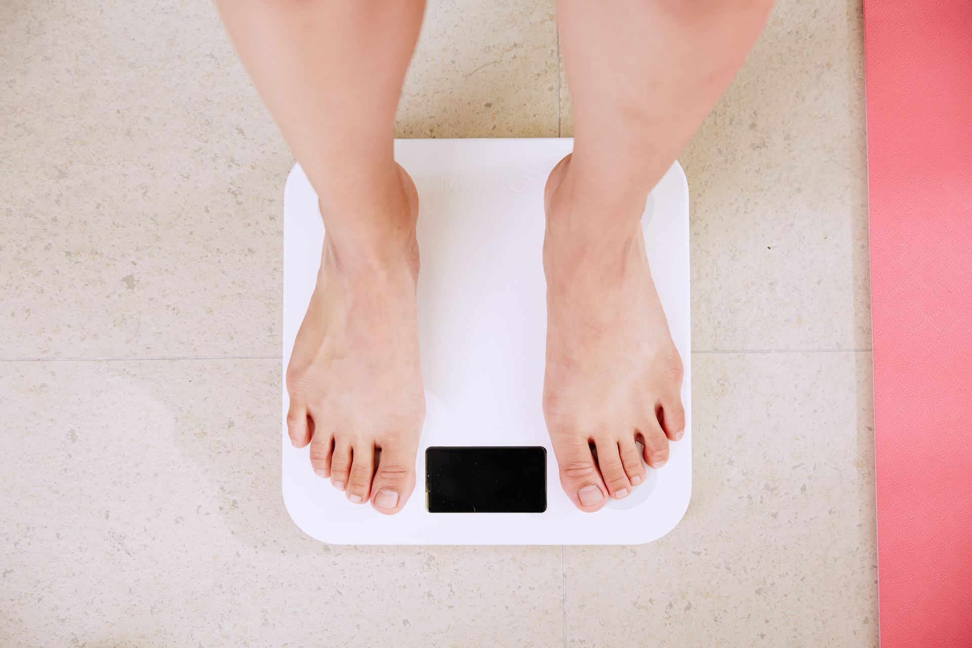 a pair of feet standing on weighing scales