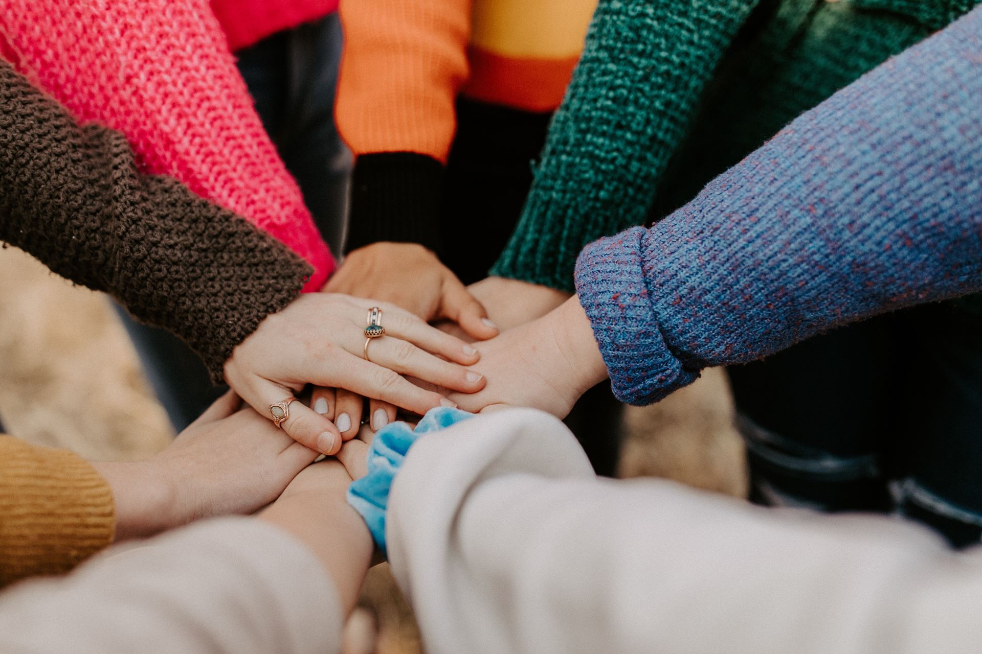 group touching hands together