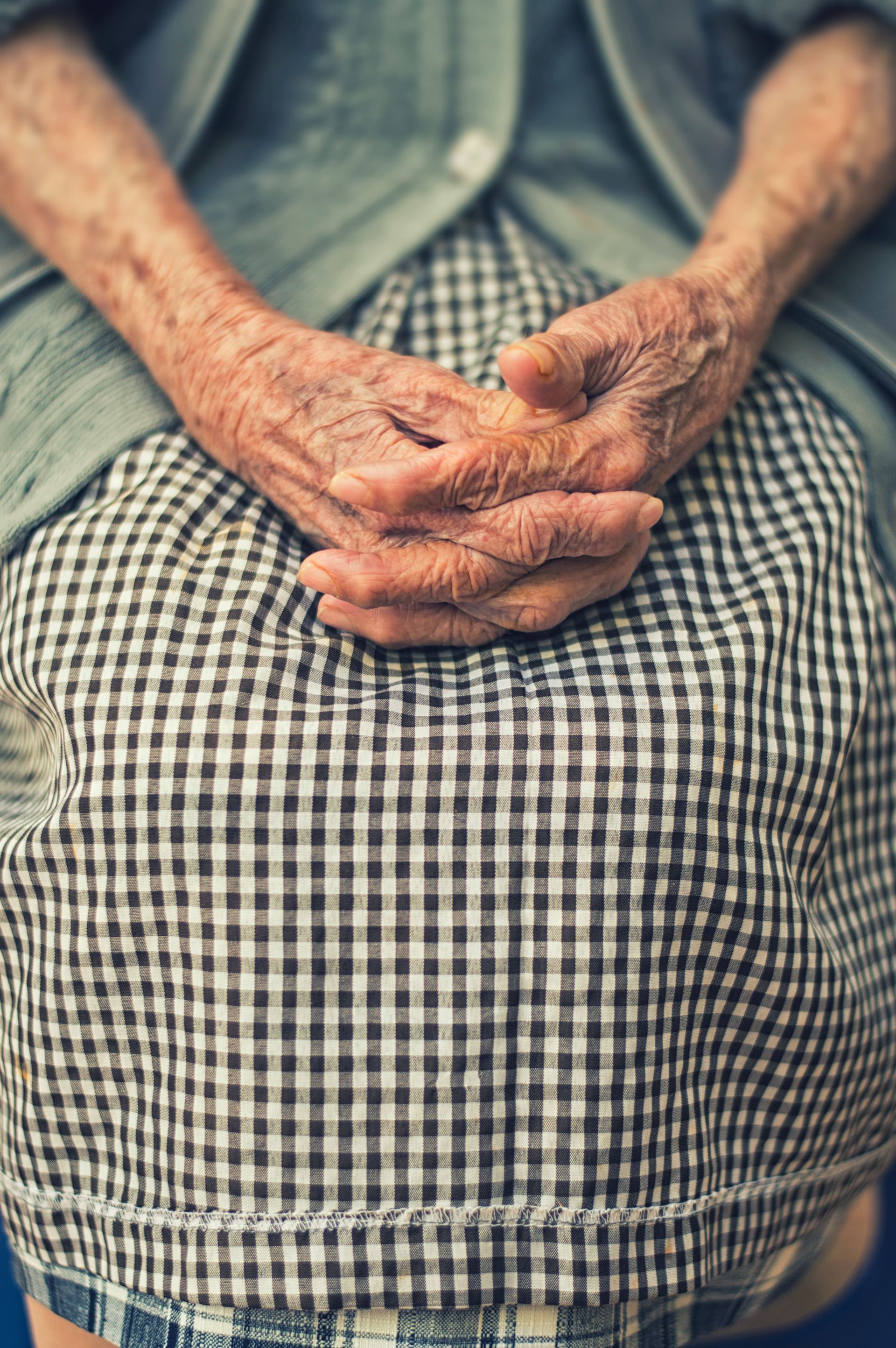 an elderly lady's hands sitting in her lap